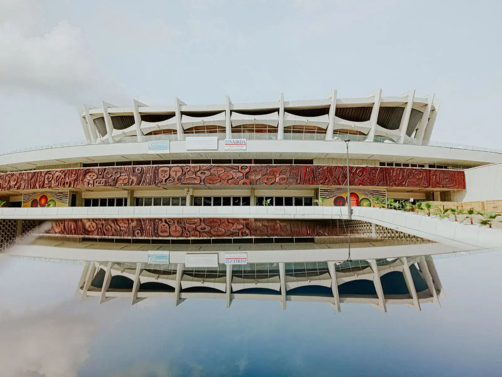 The National Arts Theatre in Lagos, mirrored in the water in front of it.